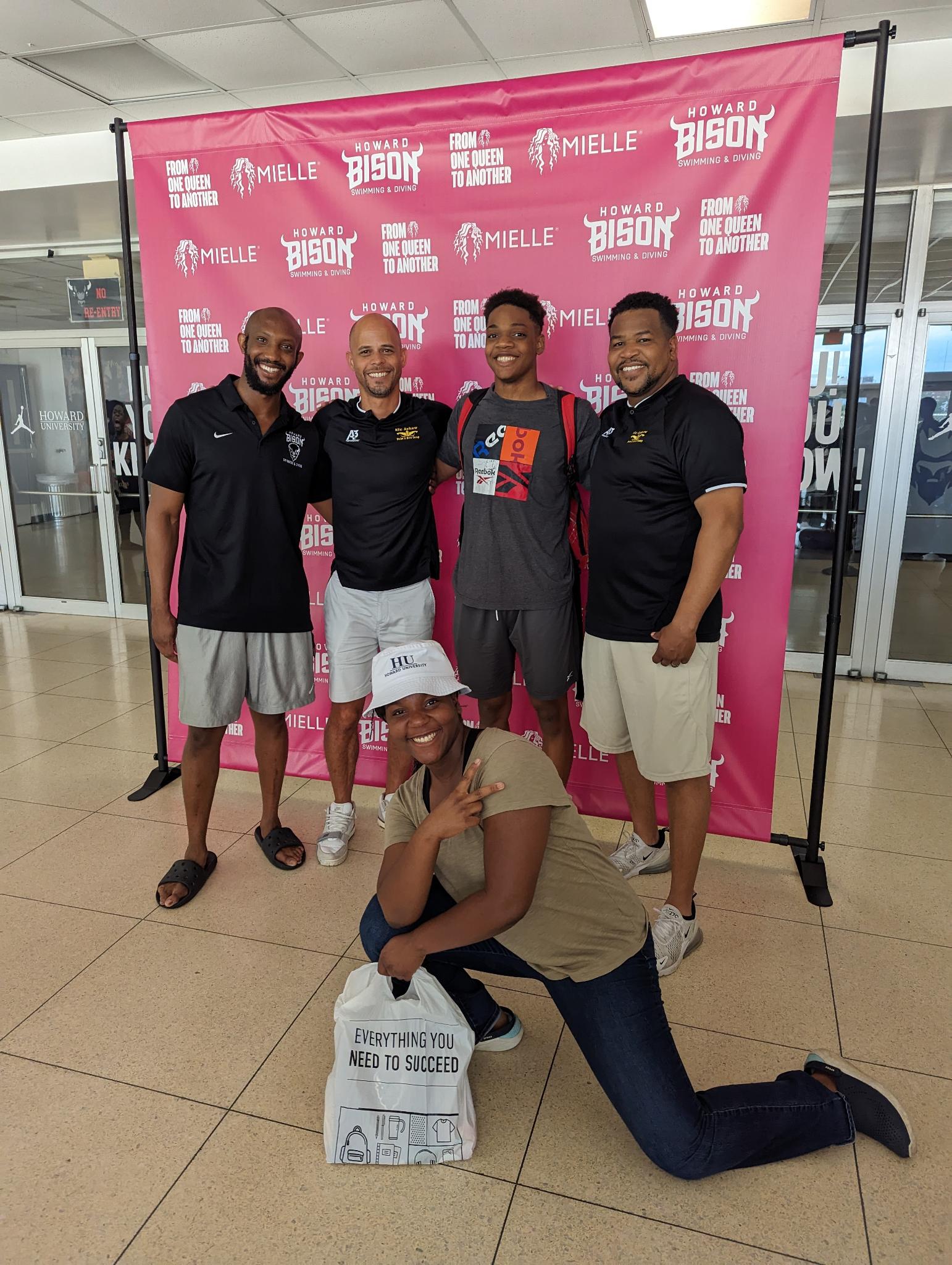 Coach Zion and athlete Judah Hall with head coach Nic Askew and coaching staff at Howard University